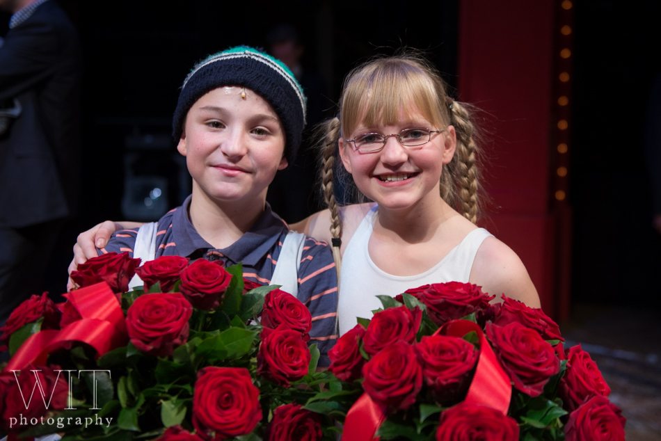 Cast members of the Dutch Billy Elliot cast holding a bouquet of red roses