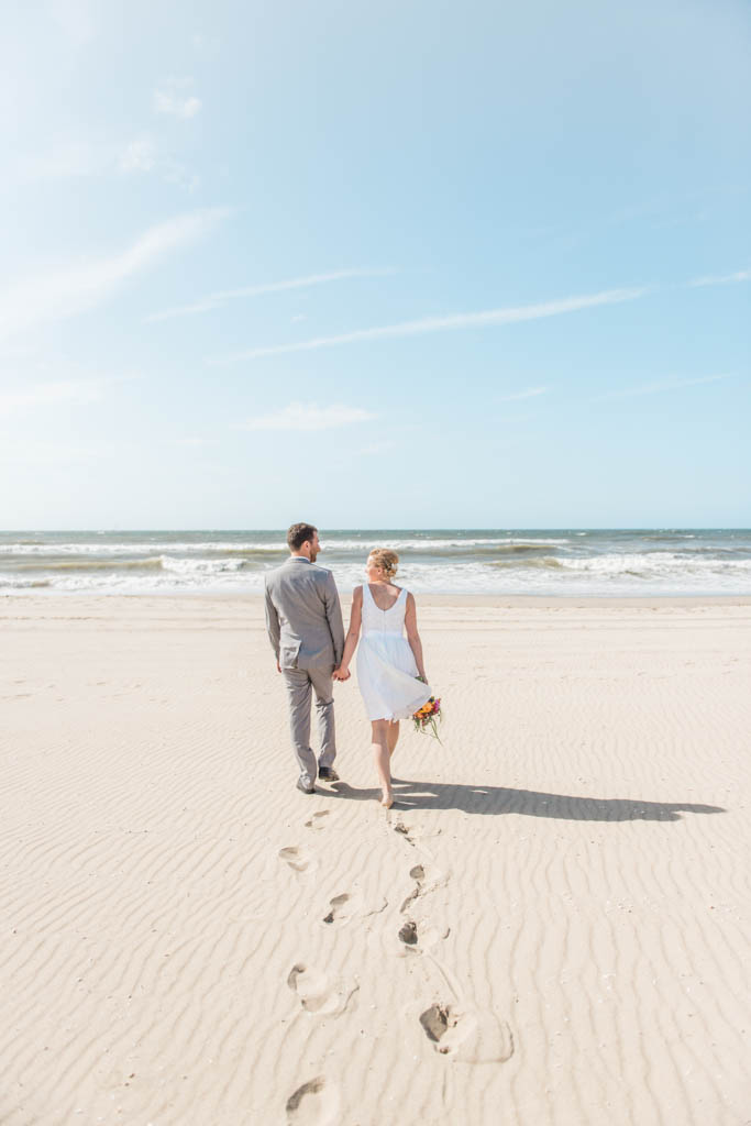 A couple walking towards the North Sea in Kijkduin in The Hague in The Netherlands