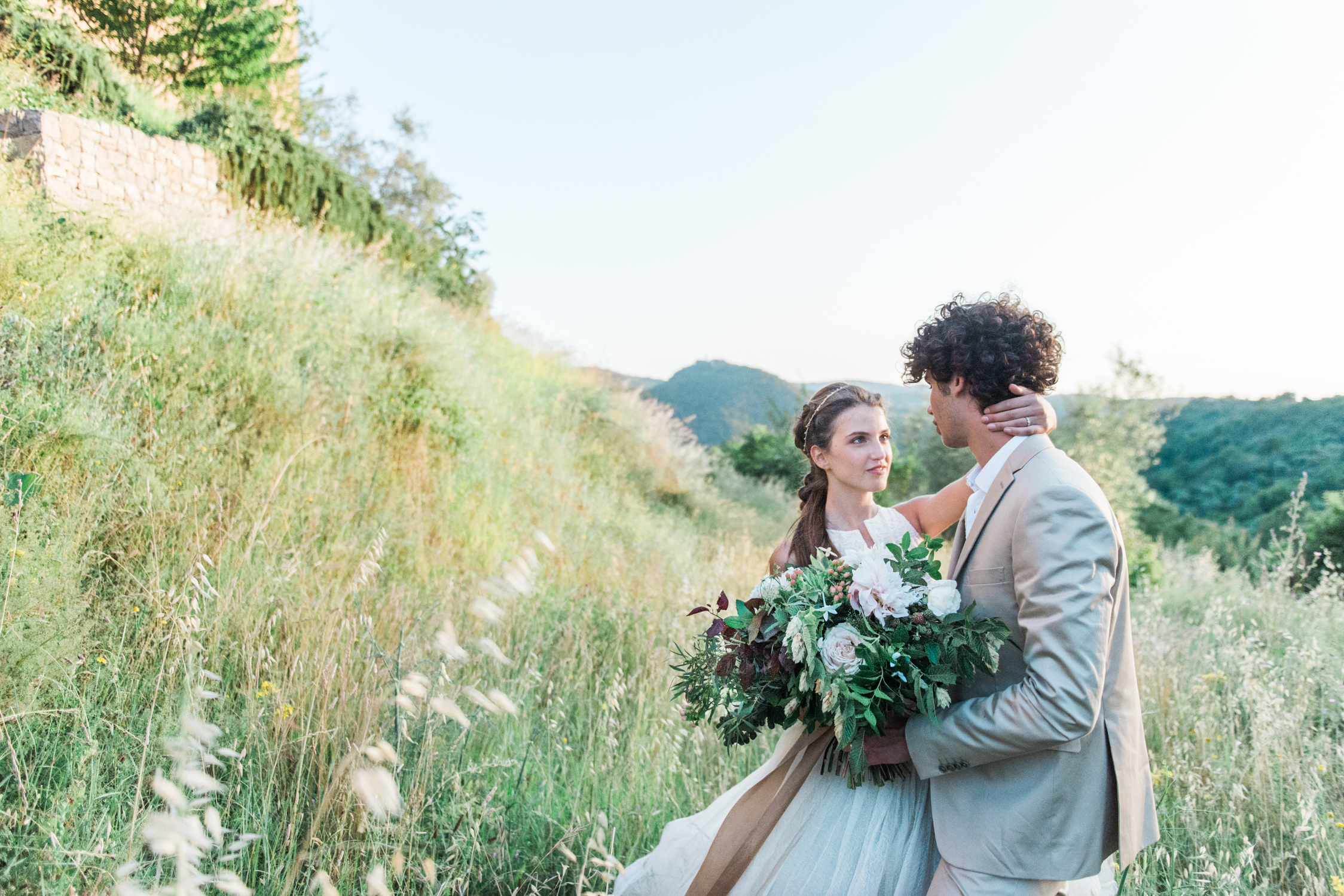 A bride and groom with a flower bouquet at Castello di Potentino in Tuscany in Italy in Europe, shot by wedding photographer Wit Photography