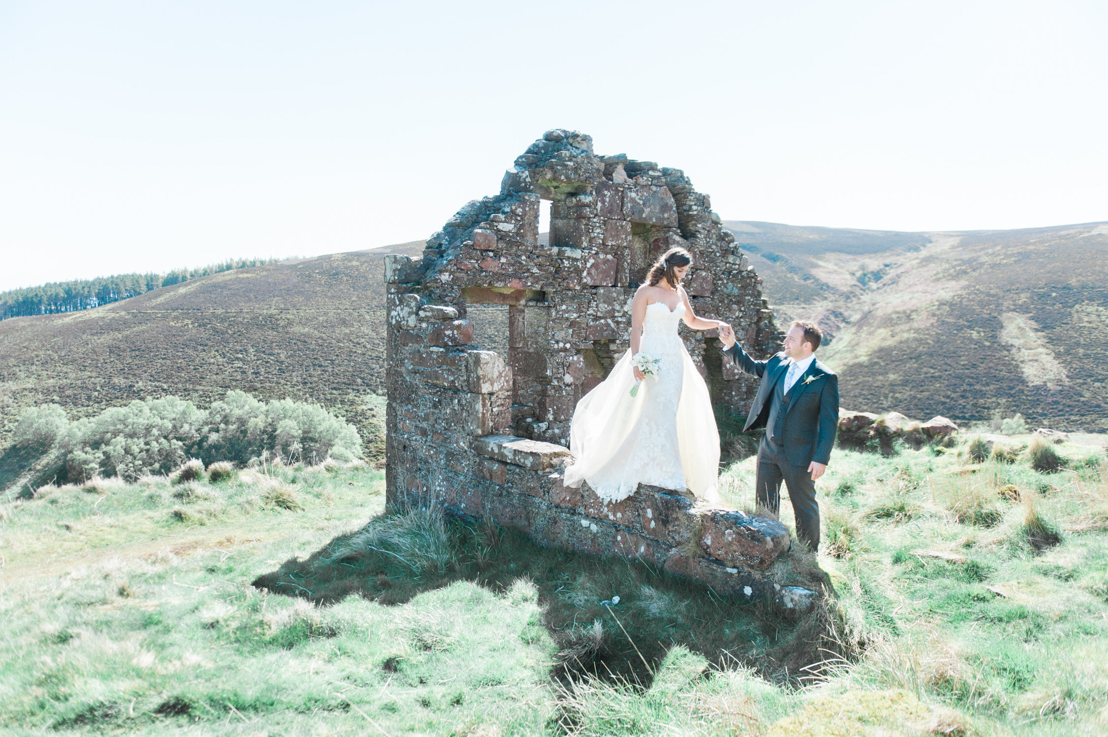 A bride and groom during their wedding photo shoot at a ruin in Scotland