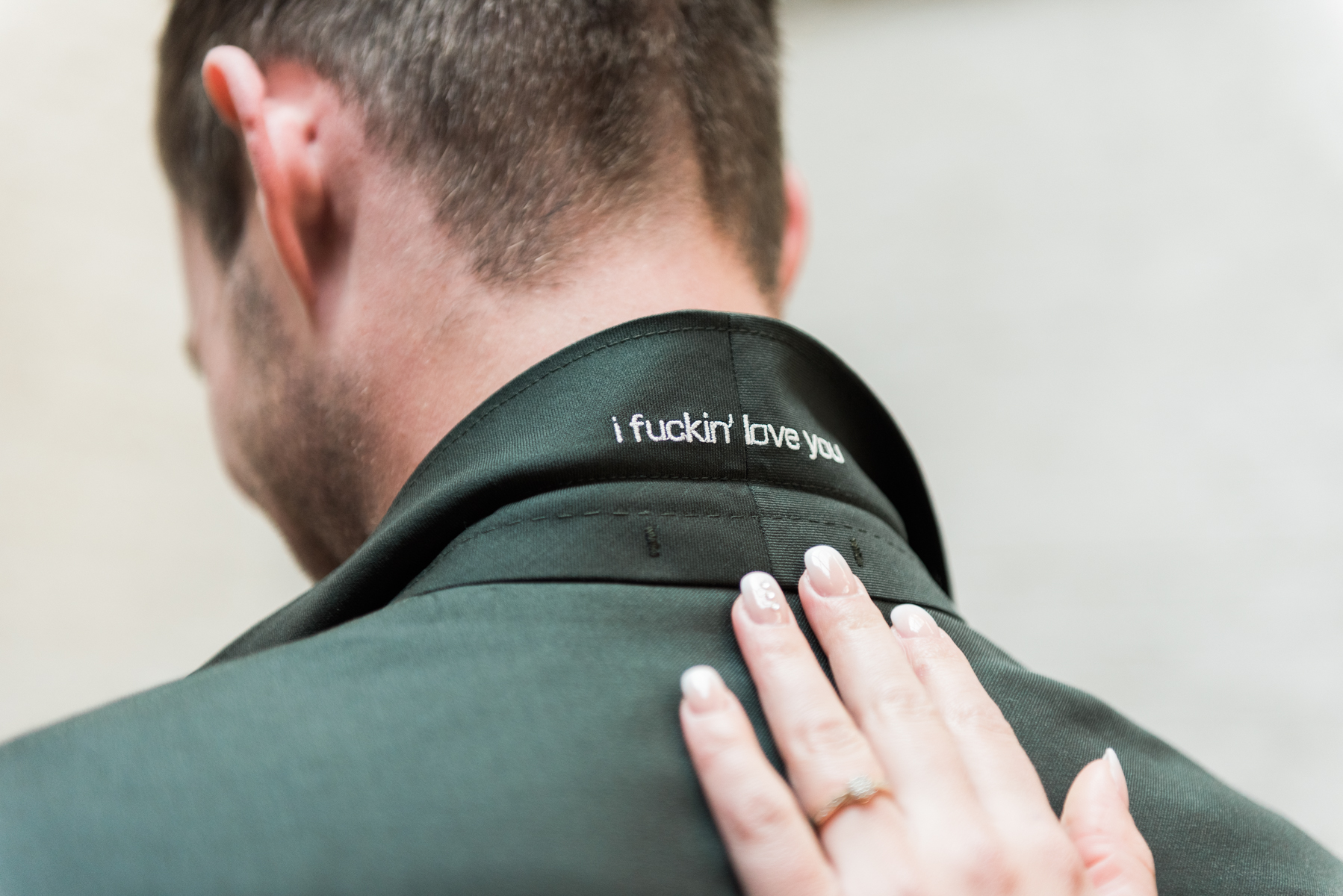 The text 'I fuckin' love you' embroiled in the collar of a groom's suit.