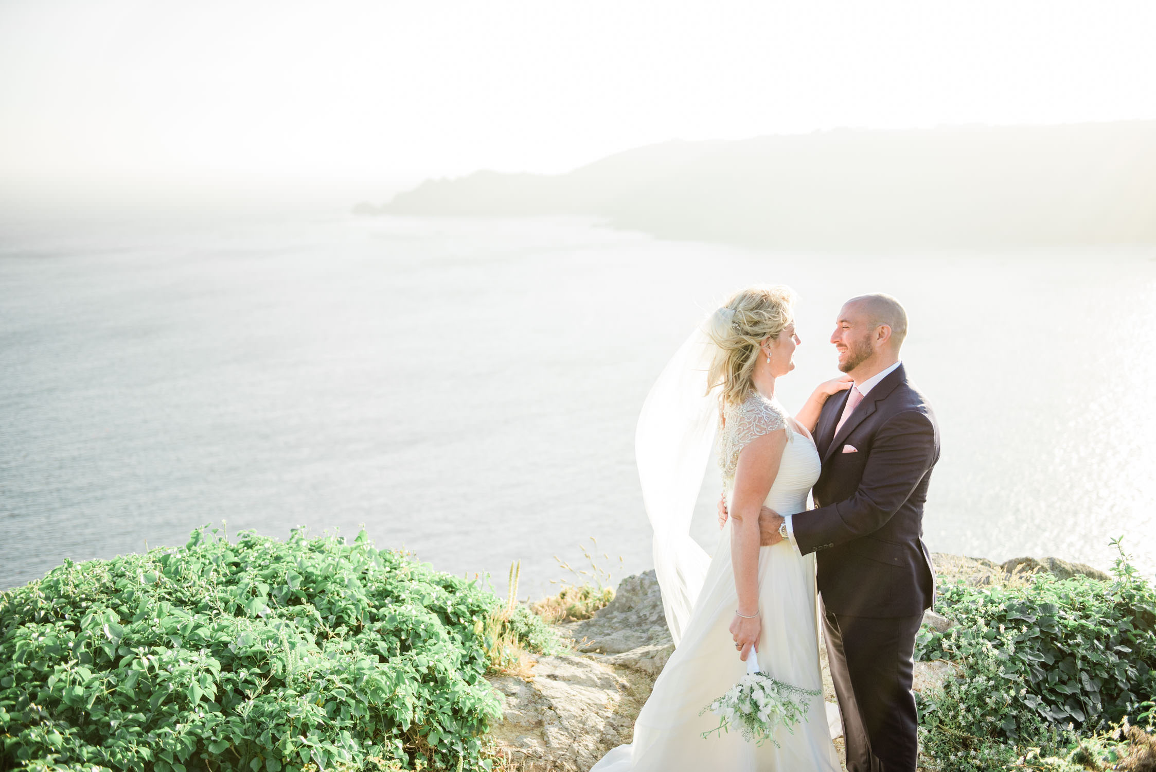 A bride and groom at a cliff in Icard, Guernsey