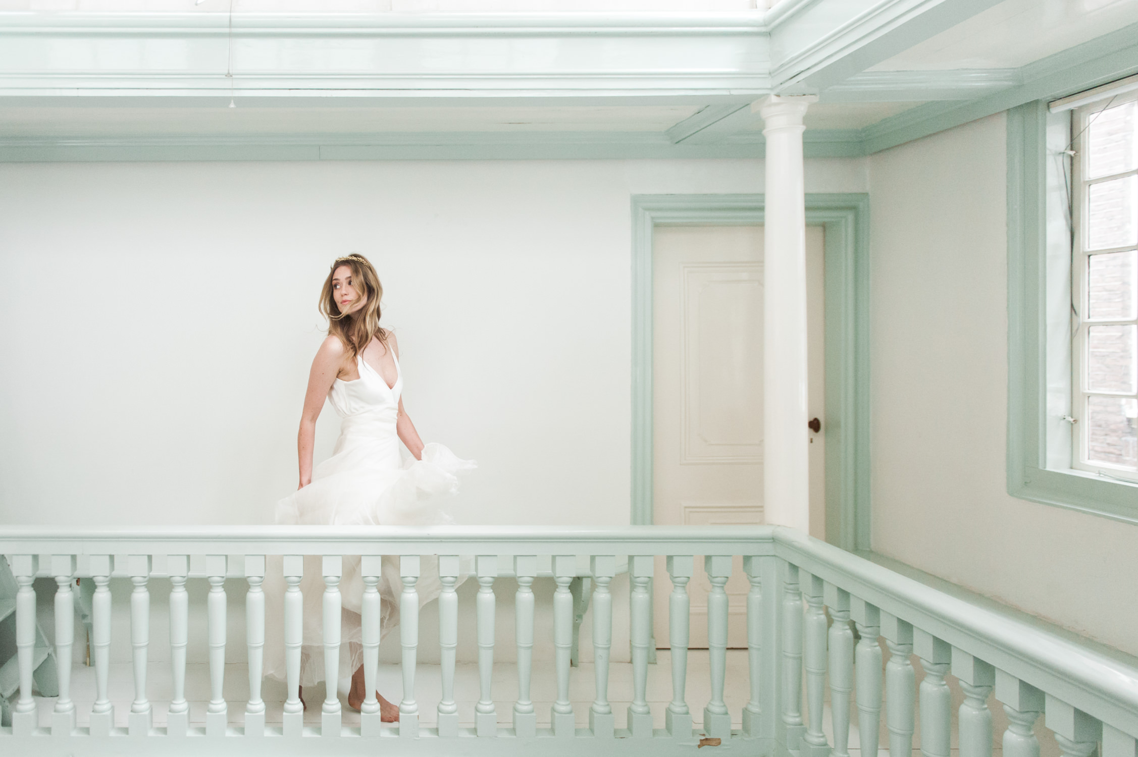 Fine art wedding photography of a bride running in a gallery