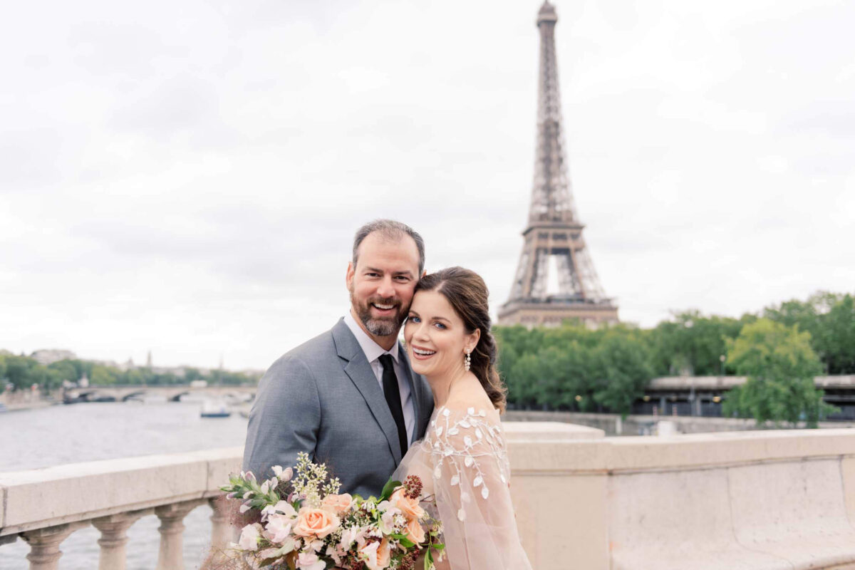 A bride and groom in front of the Eiffel Tower during their elopement in Paris