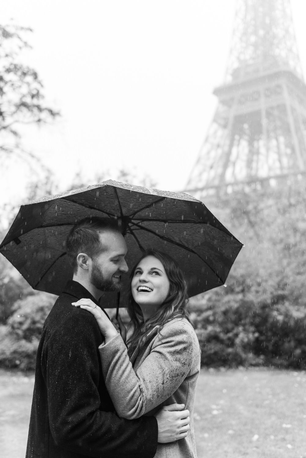 American couple photographed on the foot of the Eiffel Tower, by an English speaking couple shoot photographer in Paris