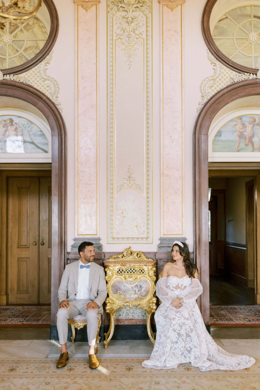 Bride and groom inside of the pink salon at Palacio de Estoi in Algarve, Portugal